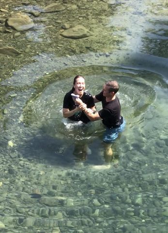 Lauren Woyke's baptism by Pastor Jake Wilkinson in the Cle Elum River on July 8, 2023
